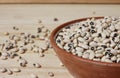 Uncooked Dried Black Eyed Peas in Bowl on Wooden Table Royalty Free Stock Photo