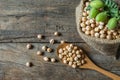Uncooked dried chickpeas in burlap sack with raw green chickpea pod plant on wooden table Royalty Free Stock Photo