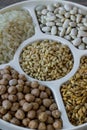 Uncooked dried chickpeas, wheat, rice and white beans in divided plate.Ashure Day Royalty Free Stock Photo