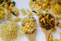 Dry bow-tie pasta or farfalle pasta on wooden spoon on white Royalty Free Stock Photo