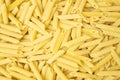 Uncooked or dry penne lisce type of pasta texture background Royalty Free Stock Photo