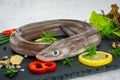 Uncooked eel fish, conger,parsley, salt and lemon - ingredients for cooking Royalty Free Stock Photo