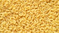 Uncooked elbow macaroni pasta top view full background