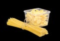 Uncooked farfalle pasta in plastic tray and long pasta Royalty Free Stock Photo