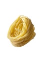 Uncooked fettuccine, noodles pasta nest isolated on white background, levitating food