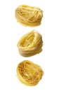 Uncooked fettuccine, noodles pasta nest set isolated on white background, levitating food