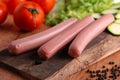 Uncooked frankfurters with fresh vegetables Royalty Free Stock Photo