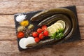 Uncooked fresh eel with spices, vegetables and lemon close up on a slate board. horizontal top view Royalty Free Stock Photo