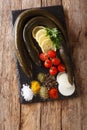 Uncooked fresh eel with spices, vegetables and lemon close up on a slate board. Vertical top view Royalty Free Stock Photo