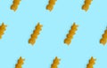 Uncooked fusilli pasta isolated on blue seamless background. Itallian spiral pasta close-up on blue seamless pattern