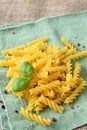 Uncooked gluten free fusilli pasta from blend of corn and rice flour