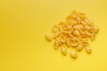 Uncooked gnocchi pasta. Raw italian pasta on yellow background