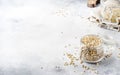 Uncooked green buckwheat groat in glass jar, healthy vegetarian food on gray kitchen table, copy space, selective focus