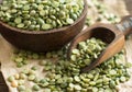 Uncooked Green Split Peas in a bowl with a spoon Royalty Free Stock Photo