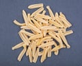 Uncooked Italian Casarecce pasta made from organic durum wheat semolina on natural stone. Macaroni product.