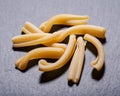 Uncooked Italian Casarecce pasta made from organic durum wheat semolina on natural stone. Macaroni product.