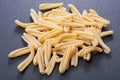 Uncooked Italian Casarecce pasta made from organic durum wheat semolina on natural stone. Macaroni product.