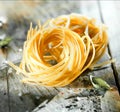 Uncooked Italian linguine or tagliatelli pasta Royalty Free Stock Photo