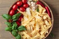 Uncooked Italian noodles with garlic, basil, tomatoes cherry and Royalty Free Stock Photo