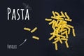 Uncooked Italian pasta Fusilli on black slate stone background