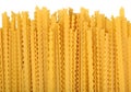 Uncooked Italian pasta mafaldine on a white Royalty Free Stock Photo