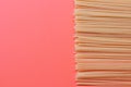 Uncooked italian pasta on orange background. Monochromatic image with spaghetti.
