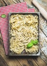 Uncooked Italian pasta in wooden tray over rustic background Royalty Free Stock Photo