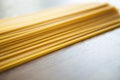 Uncooked Italian row of spaghetti on wooden table, Selective focus.