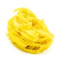 Uncooked Italian tagliatelle on a white background