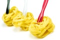 Uncooked Italian tagliatelle on a white background