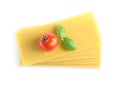 Uncooked lasagna sheets, tomato and basil on background, top view Royalty Free Stock Photo