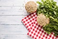 Uncooked lentils in wooden bowles with parsley herbs on kitchen table