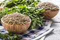 Uncooked lentils in wooden bowles with parsley herbs on kitchen