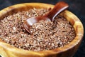 Uncooked linseed in wooden spoon, rustic style. Healthy linseed