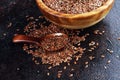 Uncooked linseed in wooden spoon, rustic style. Healthy linseed