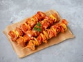 Uncooked marinated and rubbed chiken or turkey shish kebabs on skewers with onion, pepper and tomato ready for grilling or BBQ.