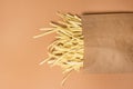 Uncooked Noodle Dried Homemade Wheat Noodles in a Craft Package Light Brown Background Top View Horizontal Copy Space