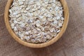 Uncooked oatmeal or oat flakes in a wooden bowl Royalty Free Stock Photo