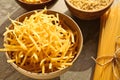 Uncooked pasta in bowl on table