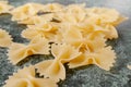 Uncooked pasta farfalle on the table.