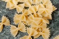 Uncooked pasta farfalle on the table. View from above