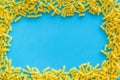 Uncooked pasta frame for italian food on blue table background top view copyspace Royalty Free Stock Photo