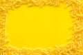 Uncooked pasta frame for italian food on yellow table background top view copyspace Royalty Free Stock Photo