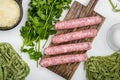 Uncooked Pasta sausage carbonara ingredients, on white stone table background, top view flat lay Royalty Free Stock Photo