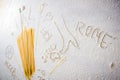 Uncooked pasta spaghetti macaroni and italian flag on floured white background. Royalty Free Stock Photo