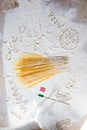 Uncooked pasta spaghetti macaroni and italian flag. Words Venice, Rome and Pasta written in flour