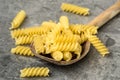 Uncooked pasta in wooden spoon Royalty Free Stock Photo