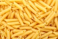 Uncooked penne pasta as background