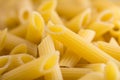 Uncooked penne pasta background. Close-up