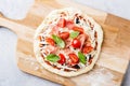 Uncooked pizza dough with toppings Royalty Free Stock Photo